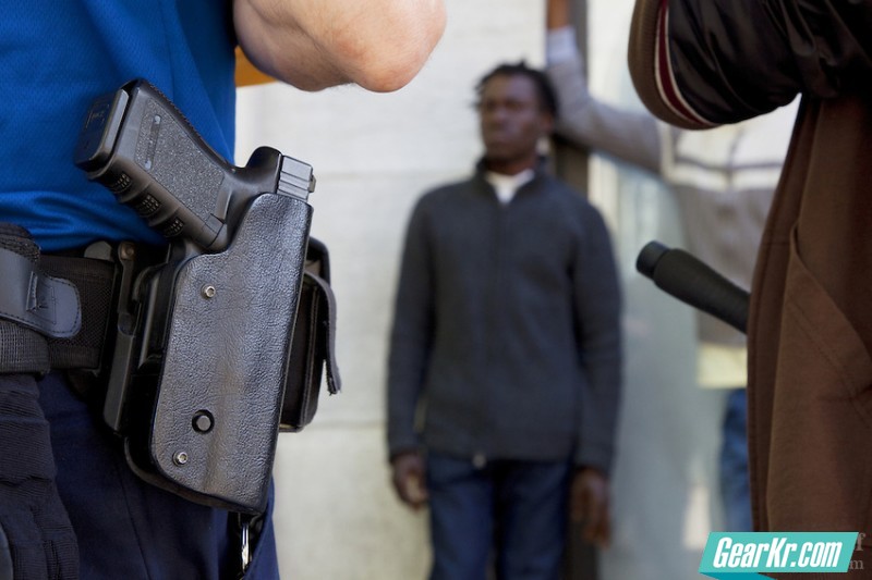 Policemen. Convict. African man. Arrest. Gun. Glock.